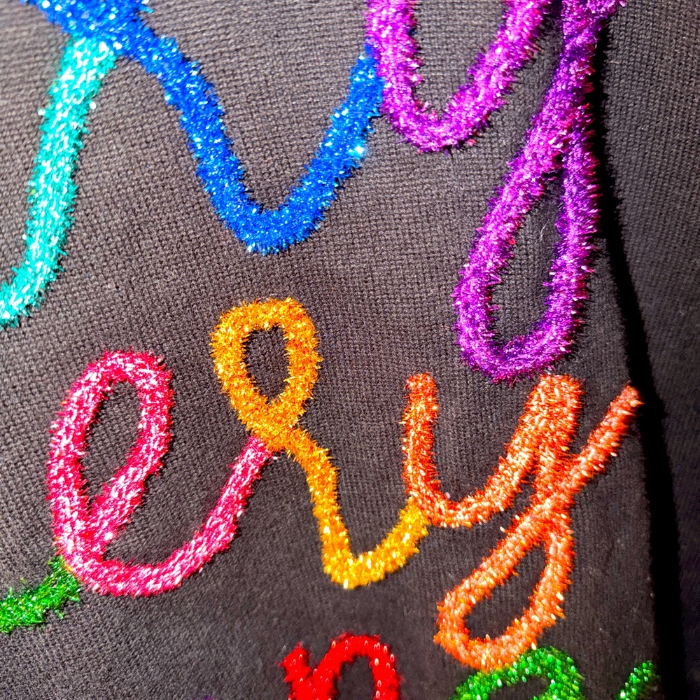 "Merry Everything" Glitter Script Sweater by the brand Queen of Sparkles.